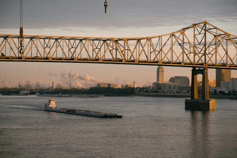 A photo of Baton Rouge and a bridge goes over a river.